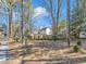 Backyard landscape with brick retaining wall, landscaping and a view of neighboring houses at 3428 Singleleaf Ln, Raleigh, NC 27616