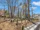 Backyard landscape with brick retaining wall, landscaping and a view of neighboring houses at 3428 Singleleaf Ln, Raleigh, NC 27616