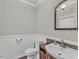 Cozy bathroom with decorative mirror and wood-look accent backsplash at 3428 Singleleaf Ln, Raleigh, NC 27616