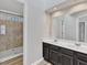 Bathroom featuring a dual vanity, a large mirror and tile flooring at 3428 Singleleaf Ln, Raleigh, NC 27616
