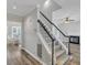 Inviting entryway featuring a staircase, hardwood floors, and a view into the adjacent living room and dining room at 3428 Singleleaf Ln, Raleigh, NC 27616