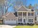 Charming two-story home with a well-manicured lawn, attached two car garage, and welcoming front porch at 3428 Singleleaf Ln, Raleigh, NC 27616