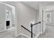 Upstairs hallway with neutral carpet and open doorways leading to other rooms at 3428 Singleleaf Ln, Raleigh, NC 27616