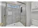 Modern shower with a glass door and a window for natural light at 3428 Singleleaf Ln, Raleigh, NC 27616