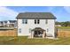 Well-maintained backyard with a covered patio, fenced yard, and lush green lawn at 35 Wolf Ridge Ct, Willow Springs, NC 27592