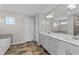 Modern bathroom featuring a dual sink vanity, tile flooring, and a separate soaking tub at 35 Wolf Ridge Ct, Willow Springs, NC 27592