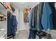 Walk-in closet with built-in shelving and rods for storage, offering ample space at 35 Wolf Ridge Ct, Willow Springs, NC 27592