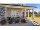Charming front porch with stone accents, comfortable seating, and manicured landscaping at 35 Wolf Ridge Ct, Willow Springs, NC 27592