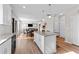 Open-concept kitchen flows into a living area featuring a granite island with pendant lighting at 35 Wolf Ridge Ct, Willow Springs, NC 27592