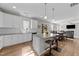 Modern open-concept kitchen leads to a living area, with granite island and stainless appliances at 35 Wolf Ridge Ct, Willow Springs, NC 27592