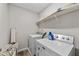 Functional laundry room equipped with appliances, shelving, and storage solutions at 35 Wolf Ridge Ct, Willow Springs, NC 27592
