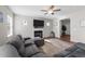Living room with a ceiling fan, fireplace, and an oversized sectional sofa at 35 Wolf Ridge Ct, Willow Springs, NC 27592