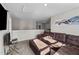 Open living area with a leather sectional sofa and ottoman, complemented by soft carpeting at 35 Wolf Ridge Ct, Willow Springs, NC 27592