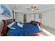 Well-lit primary bedroom with tray ceilings, a ceiling fan, and a view into the ensuite bathroom at 35 Wolf Ridge Ct, Willow Springs, NC 27592