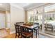 Bright dining area with a wooden table, chairs, and sliding glass doors leading to an outdoor space at 3504 Griffice Mill Rd, Raleigh, NC 27610