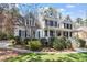 Beautiful two-story house featuring a brick facade, inviting front porch, and professionally landscaped yard at 3504 Griffice Mill Rd, Raleigh, NC 27610
