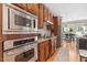Well-lit kitchen featuring stainless steel appliances, granite countertops, and wood cabinets at 3504 Griffice Mill Rd, Raleigh, NC 27610