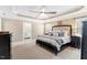 Main bedroom with a tray ceiling, neutral colors, carpet, and an ensuite bathroom at 3504 Griffice Mill Rd, Raleigh, NC 27610