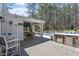 Inviting outdoor space with a built-in kitchen, covered dining area, and view of the pool and wooded surroundings at 3504 Griffice Mill Rd, Raleigh, NC 27610