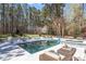 Gorgeous swimming pool with sunbathing chairs and lounge seating surrounded by lush greenery and tall trees at 3504 Griffice Mill Rd, Raleigh, NC 27610