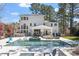 Beautiful backyard featuring a sparkling pool, patio with lounge area, and well-manicured landscaping at 3504 Griffice Mill Rd, Raleigh, NC 27610