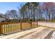 Wooden deck with railing overlooks a lush backyard and trees at 4005 Freesia Ct, Zebulon, NC 27597