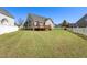 Large backyard with a wooden deck and a white picket fence at 4005 Freesia Ct, Zebulon, NC 27597
