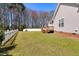 Spacious backyard with a wooden deck and a white picket fence at 4005 Freesia Ct, Zebulon, NC 27597