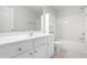 Bright bathroom with a vanity, mirror, and a shower-tub combo at 4005 Freesia Ct, Zebulon, NC 27597