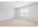Bright, carpeted bedroom features a window providing natural light and neutral wall paint at 4005 Freesia Ct, Zebulon, NC 27597
