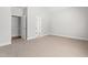 Spacious bedroom with light carpet, white walls, and access to the bathroom through open door at 4005 Freesia Ct, Zebulon, NC 27597