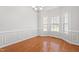 An empty dining room featuring hardwood floors, decorative molding, and a chandelier at 4005 Freesia Ct, Zebulon, NC 27597
