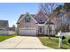Charming two-story home with a well-manicured lawn, two-car garage, and a cozy front porch at 4005 Freesia Ct, Zebulon, NC 27597