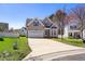 Inviting two-story home with a spacious driveway and a beautifully landscaped front yard at 4005 Freesia Ct, Zebulon, NC 27597