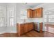 Modern kitchen featuring wood cabinets, stainless steel appliances, white subway tile backsplash, and bright windows at 4005 Freesia Ct, Zebulon, NC 27597