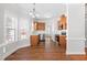 Open kitchen with wood cabinets, stainless steel appliances, bright windows, and view into the dining area at 4005 Freesia Ct, Zebulon, NC 27597