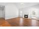 Bright living room featuring hardwood floors, a fireplace, large windows and high ceilings at 4005 Freesia Ct, Zebulon, NC 27597