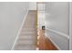 Carpeted staircase leads to the second level, with view of living room fireplace at 4005 Freesia Ct, Zebulon, NC 27597