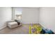 Cozy bedroom with a chair, a colorful rug, and a window providing natural light at 417 Sapphire Rd, Burlington, NC 27215