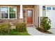 Charming front entrance with stone accents, decorative plants, and a wooden door with decorative glass at 417 Sapphire Rd, Burlington, NC 27215
