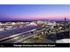 Expansive aerial view of Raleigh-Durham International Airport with airplane parking and highway at 4720 Cypress Tree Ln, Raleigh, NC 27612