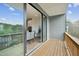 Outdoor balcony with wood floors and railing with a sliding door to the dining room at 4720 Cypress Tree Ln, Raleigh, NC 27612