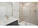 Modern bathroom featuring a tiled shower and vanity with gold colored hardware at 4720 Cypress Tree Ln, Raleigh, NC 27612