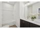 Clean bathroom featuring a double sink, a shower and tub combo, and modern fixtures at 4720 Cypress Tree Ln, Raleigh, NC 27612