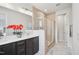 Primary bathroom featuring double sinks, large mirror, and glass enclosed shower at 4720 Cypress Tree Ln, Raleigh, NC 27612