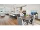 Open concept kitchen and dining area featuring a kitchen island with seating and modern finishes at 4720 Cypress Tree Ln, Raleigh, NC 27612