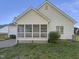 Backyard view featuring a screened porch, grassy area, and partial fencing, offering a private outdoor space at 48 Delmar Ct, Fuquay Varina, NC 27526