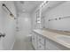 Well-lit bathroom featuring double sinks, a large mirror, and a shower-tub combo for convenience at 48 Delmar Ct, Fuquay Varina, NC 27526
