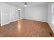Large bedroom with hardwood floors, bright windows, and a ceiling fan, offering a comfortable retreat at 48 Delmar Ct, Fuquay Varina, NC 27526