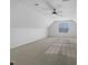 Spacious bonus room with plush carpeting, a ceiling fan, and natural light, ready for customization at 48 Delmar Ct, Fuquay Varina, NC 27526